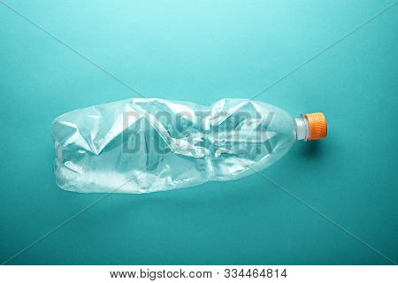 Empty Used Plastic Bottle On Neo Mint Background. Environmental Pollution Concept