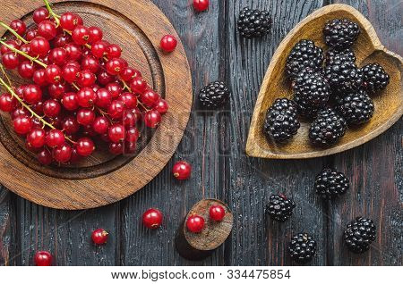 Red And Black Fruit In The Kitchen. Red Currant And Blac Kberry On A Brown Wooden Table.