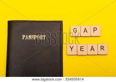 Travel Concept Showing A Passport On A Yellow Background With A Sign Reading Gap Year