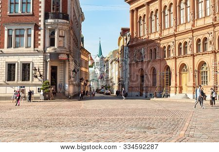 Riga, Latvia - September 5, 2019: Dome Square With Our Lady Of Sorrows Church In Background In Old T