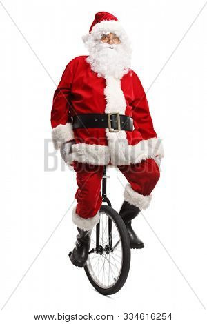 Full length portrait of santa claus on a monoc-cycle isolated on white background