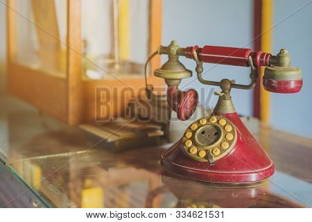A Red Telehones With Rotary Dial With Dust And Scratches And Credit Card Machine In Ancient Times Pl