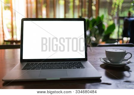 A Cup Of Cappuccino Coffee With Laptop White Screen On Table. Royalty High Quality Free Stock Photo 