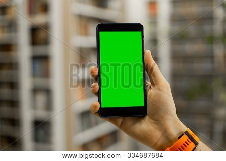 Smartphone In Hand With Green Chromakey Screen