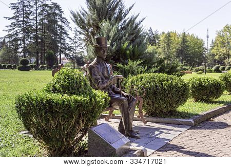 Zugdidi, Georgia, October 10, 2019 : Bronze Monument To Akaki Chanturia Sitting On A Bench - The Fir