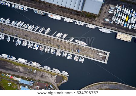 Aerial View Of Marina With Boats And Yachts From Above In Row And Pontoon