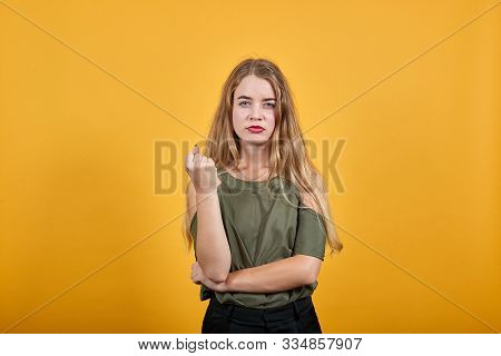 Pretty Attractive Caucasian Young Girl Over Isolated Orange Wall Wearing Fashion Clothes Keeping Fis