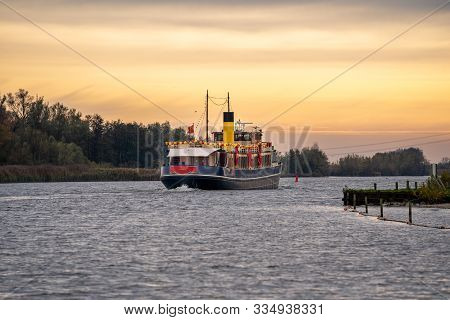 Traditional Steamboat Sailing On The Water With Festive Clothing And Package In Typical Dutch Sinter
