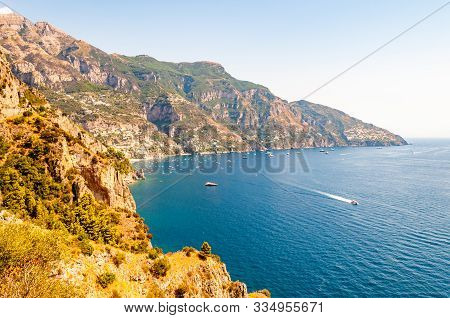 Beautiful Scenic Landscape Of Positano, Italy. Rocky Coastline Full Of Boats And Yachts Traveling Ne