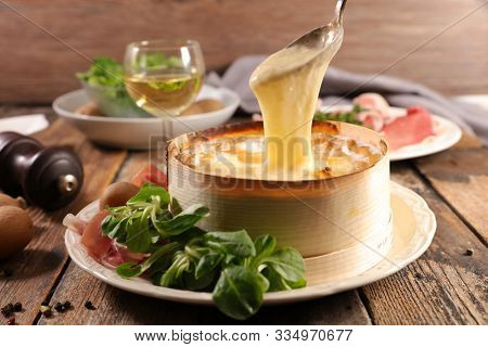 mont d'or with ham, potato, salad and wine- cheese fondue