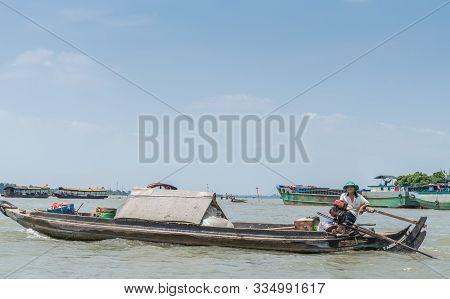 Cai Be, Mekong Delta, Vietnam - March 13, 2019: Man With Brown-gray Wooden Sloop Sailing On Wide Mek