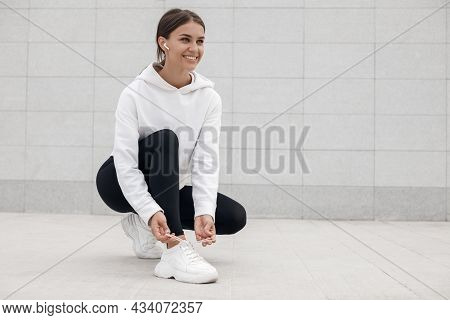 A Young Athlete Does Stretching And Warm-up Before Doing Yoga. Fitness Girl Workout In The Gym, Whit