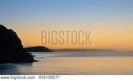 Beautiful Vibrant Late Summer Sunrise Over Pentewan Sands On English Cornwall Coast With Long Exposu