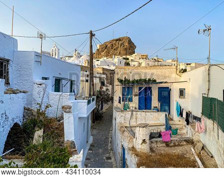 Pedestrian street of Greek Chora village built around a large rock on Amorgos island, Aegean Sea, Cyclades, Greece