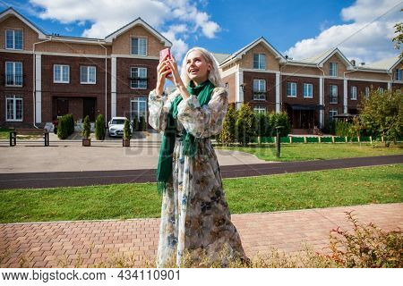 Close up portrait of young blonde woman in white dress