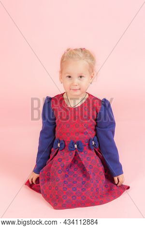 Little Girl On A Pink Background