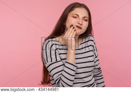 Dental Problems. Portrait Of Unhappy Sick Woman In Striped Sweatshirt Touching Sore Cheek, Frowning 