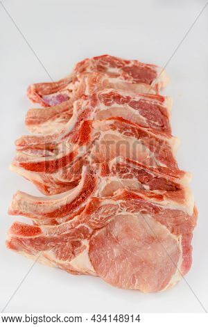 Raw Pork Chops Bone In Isoladet On White Background. Close Up.