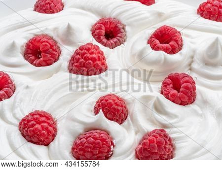 Fresh raspberries in the yoghurt or cream. Top view.