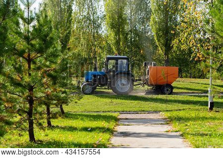 Orange Vacuum Sweeper, Towed By A Blue Tractor, Works On Street Cleaning : September 20, 2021 Agidel
