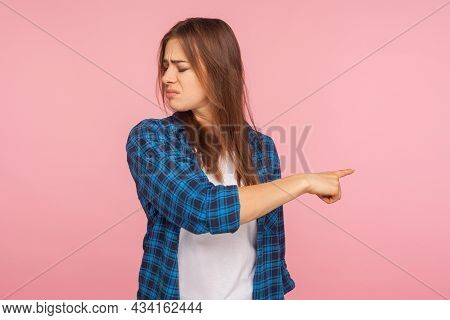 Get Out. Portrait Of Resentful Offended Girl In Checkered Shirt Frowning From Anger And Pointing Way