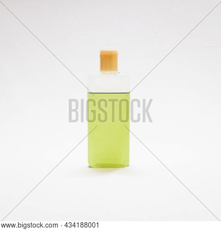 Green Natural Ayurvedic Hair Oil In A Transparent Plastic Bottle Isolated In A White Background