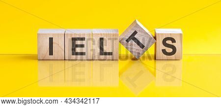 Ielts Word Written On Wood Block. Offer Word Is Made Of Wooden Building Blocks Lying On The Yellow T