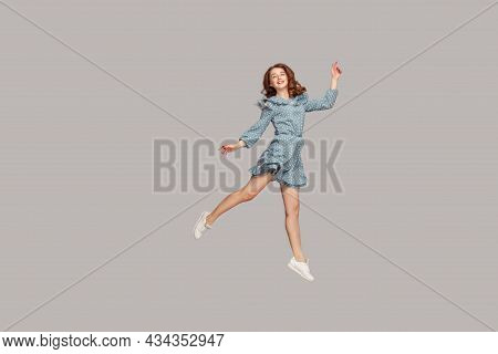 Happy Delicate Girl In Vintage Ruffle Dress Levitating With Ballet Dance Move, Hovering In Mid-air A