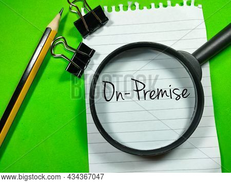 Business Concept.text On Premise Writing On Notepaper With Magnifying Glass,paper Clips And Pencil O