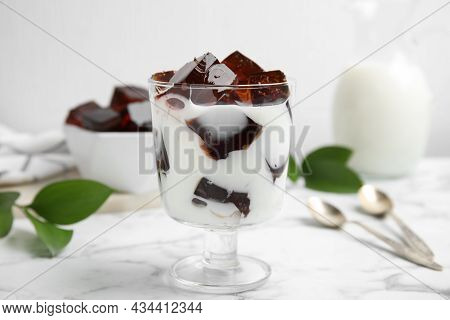 Glass Of Milk With Delicious Grass Jelly On White Marble Table