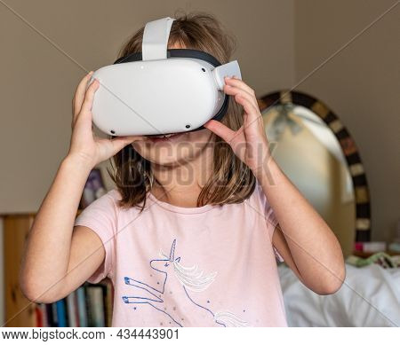 Young Girl Watching A Movie Or A Quest App On A Modern Virtual Reality Vr Headset