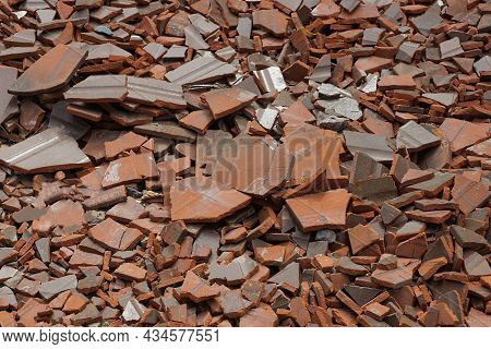 Red Brown Texture From Pieces Of Old Broken Tiles In A Pile On The Street