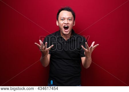 Wow And Shocked Face Of Young Asian Man With Open Hand Gesture. Advertising Model Concept.