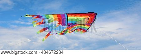 Big Kite With The Colors Of The Rainbow Symbol Of Positivity And Optimism Flies High In The Sky