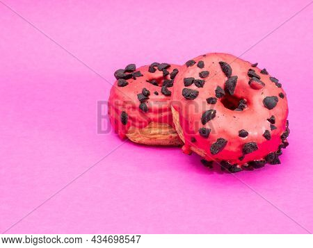 Red Cronuts On A Pink Background. High Quality Photo