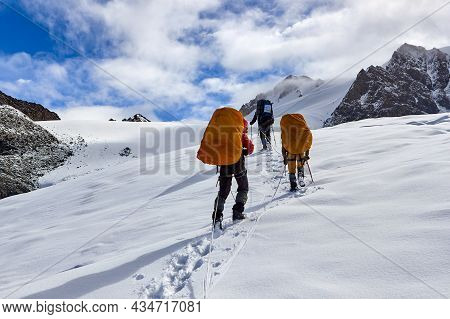 Bunch Of Mountaineers Climbs To The Top Of A Snow-capped Mountain