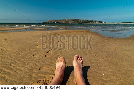 Seating On Conwy Morfa Beach In Wales In Beatiful Weather.