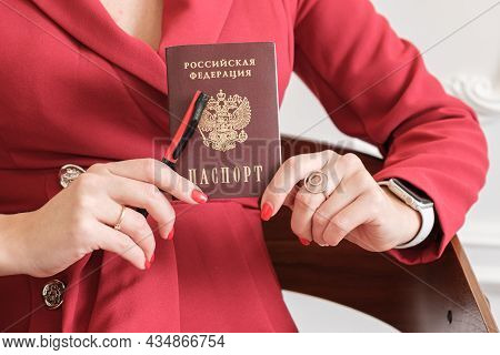 Passport Of A Citizen Of The Russian Federation In The Hands Of A Woman. The Hands Of A Woman In A R