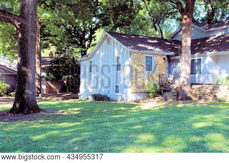 Suburban Home With A Lush Manicured Lawn And Oak Trees Taken At A Residentia Neighborhood In Kansas 