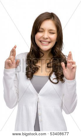 Half-length portrait of woman with fingers crossed and eyes closed, isolated on white