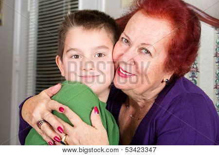 Grandmother And Grandson Cheek To Cheek Hug