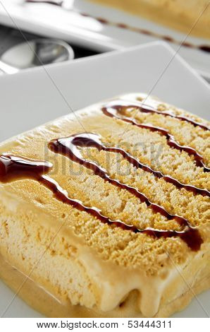 a plate with spanish turron ice cream served with syrup