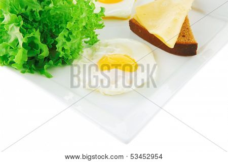eggs,cheese, salad, and bread on white plate