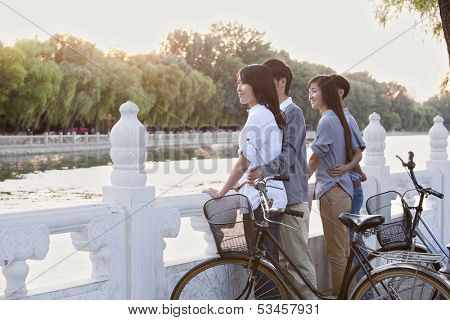 Two couples by HouHai Lake with bicycles in Beijing