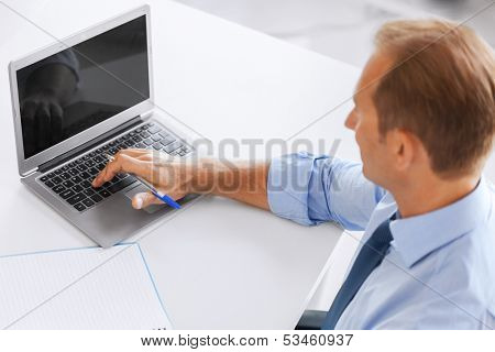 business, office, school and education concept - smiling businessman working in office