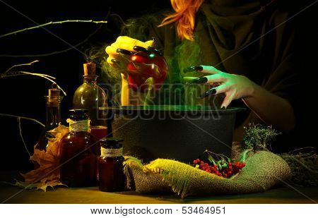  Witch in scary Halloween laboratory on dark color background