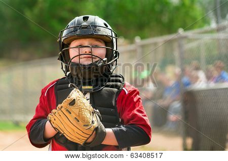 Portrait of child baseball player wearing catcher gear