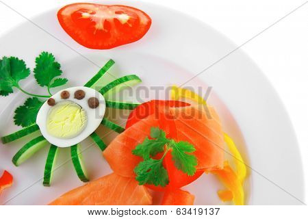 smoked salmon slices with vegetabls over white plate
