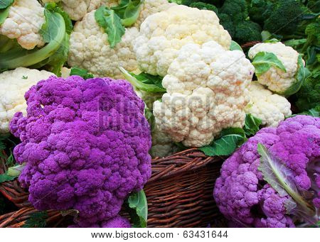 White and Purple Cauliflower in a straw basket at the Farmers market