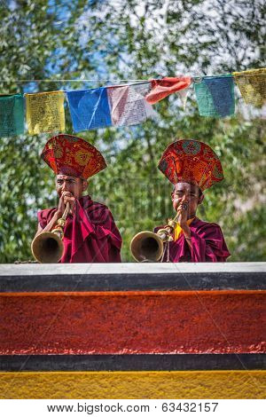 HUNDER, INDIA - SEPTEMBER 6, 2011: Tibetan Buddhist monks playing traditional musical instruments. Hunder, Nubra valley, Ladakh, India